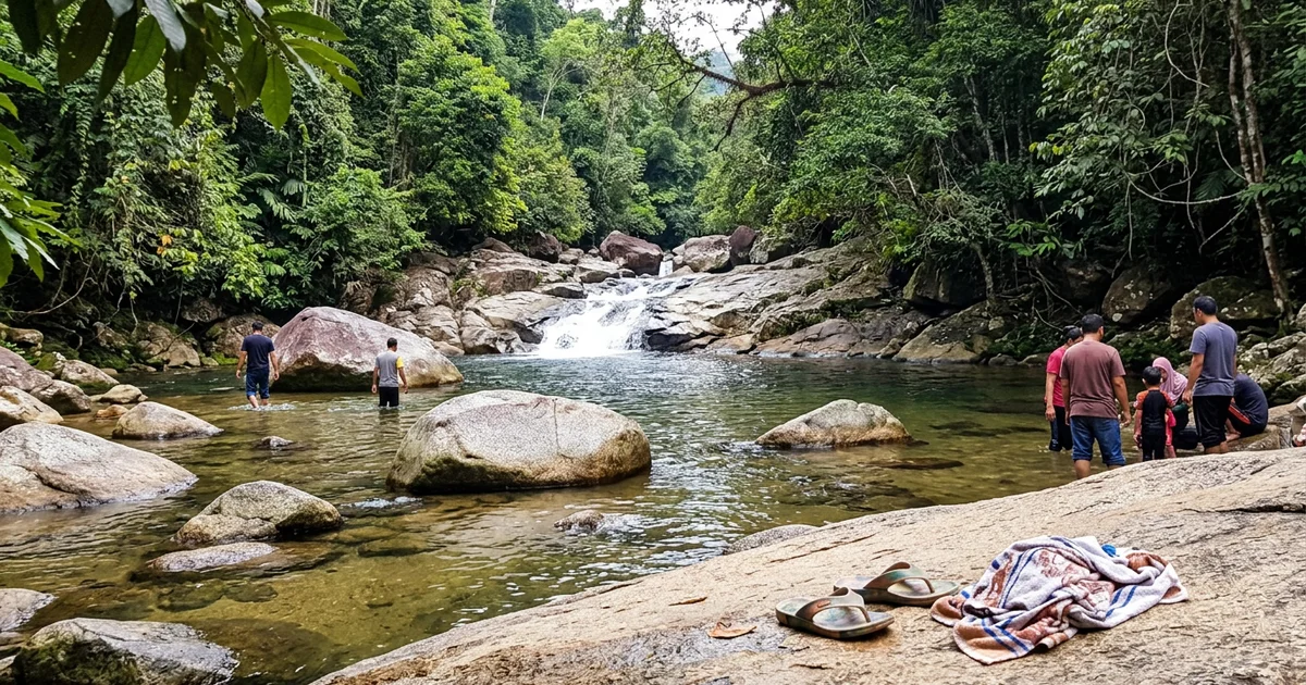 The clear river pool at Lata Berkoh with granite boulders and rainforest on both banks